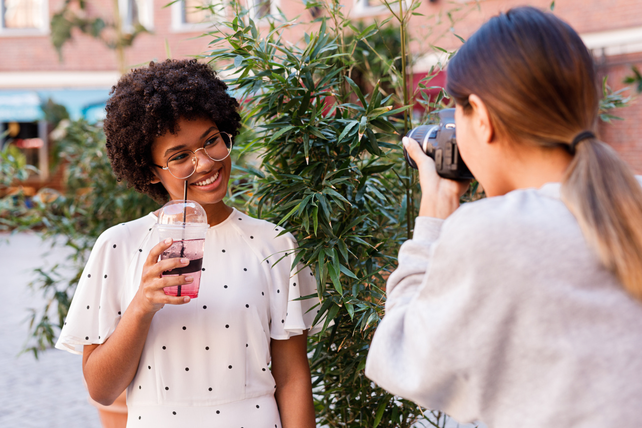 Photographer taking photos of her client outdoors